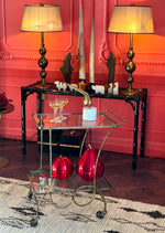 A pretty French 1950s solid brass faux bamboo bar trolley by Maison Baques with two glass shelves