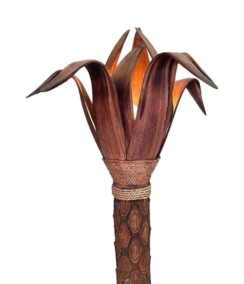 An unusual palm tree floor lamp with real palm trunk wooden base and wooden shaped leaves