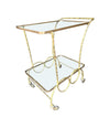 A pretty French 1950s solid brass faux bamboo bar trolley by Maison Baques with two glass shelves