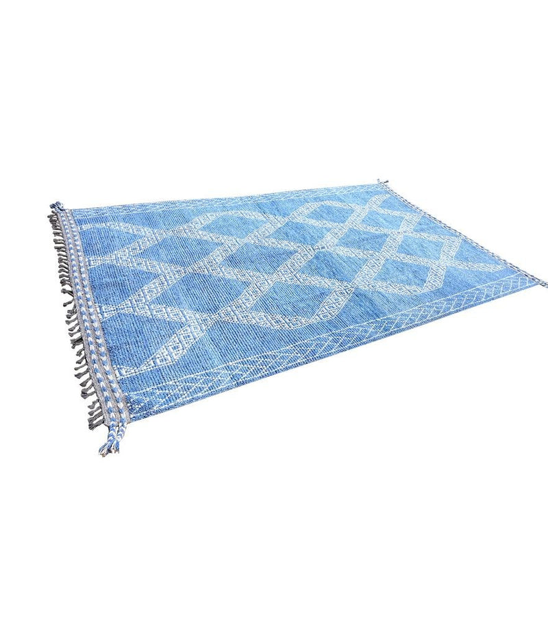 A good quality handmade Morrocan Beni Ourain with white tribal diamond and line pattern on blue background