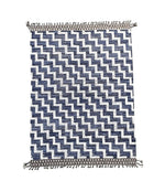 A handmade Morrocan Beni Ourain Berber rug with blue and white stepped design.