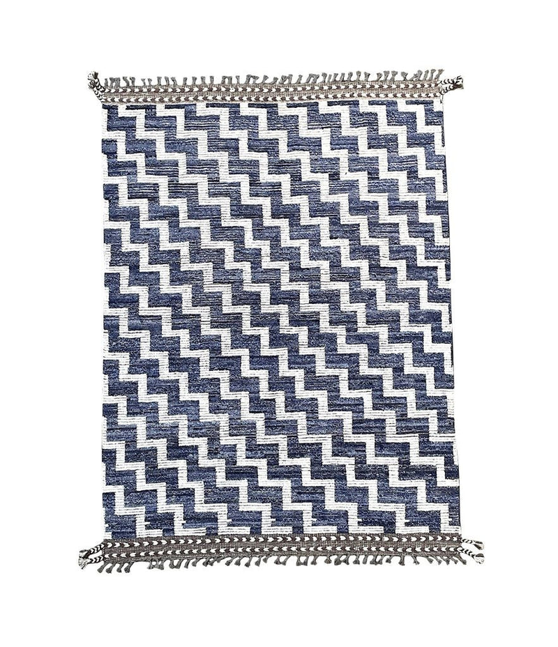 A handmade Morrocan Beni Ourain Berber rug with blue and white stepped design.