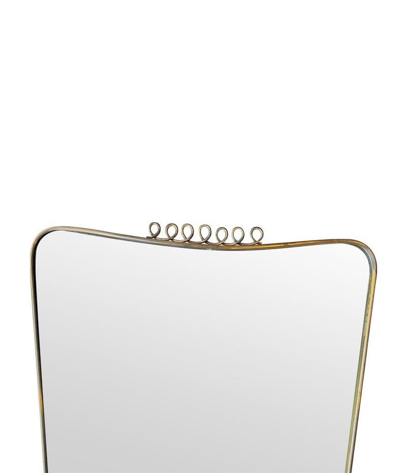 An original 1950s Italian brass framed mirror attributed to Gio Ponti with top brass squiggle detail. With original mirror plate and solid plate back.