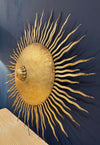 A pair of large 1950s Spanish sunburst wrought iron wall sconces