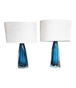 A pair of 1960s Orrefors turquoise glass and brass lamps with new bespoke linen shades