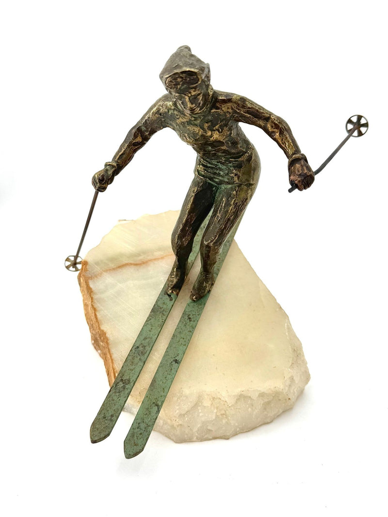 A large pair of bronze cast skiers by Curtis Jere mounted on onyx slabs