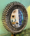 A Spanish 1960s silvered metal landscape or portrait oval eyelash mirror