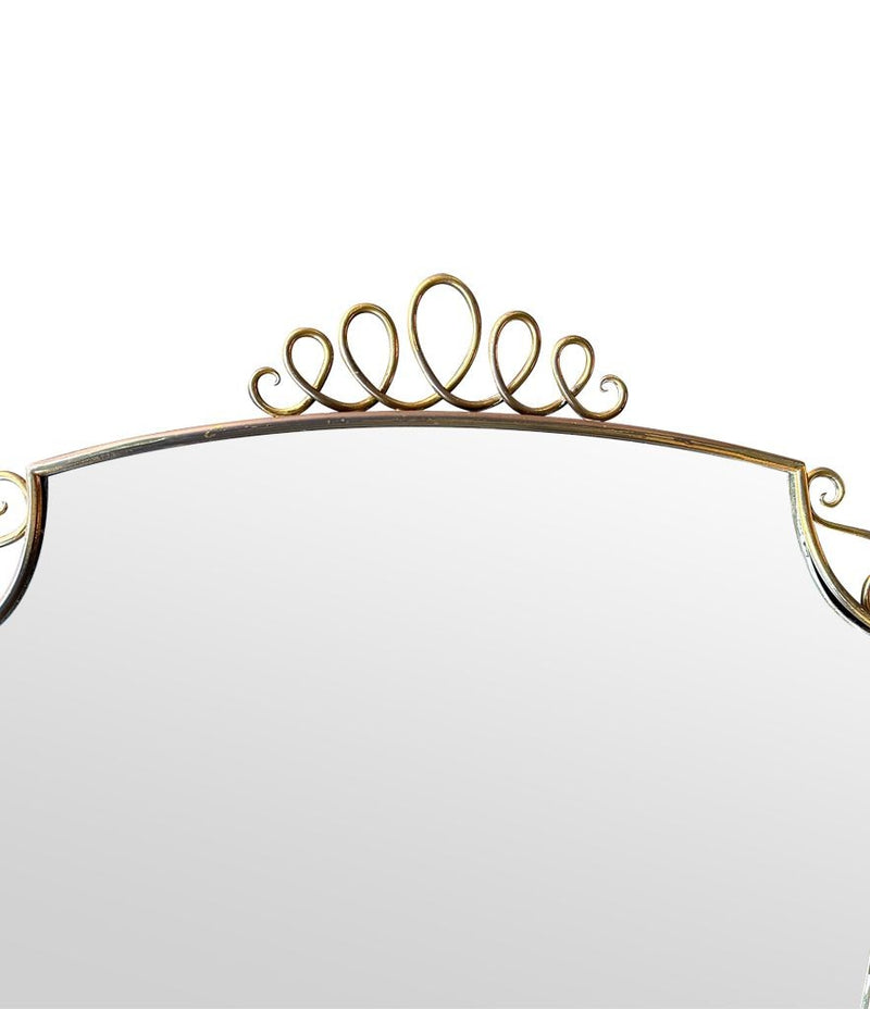 An orignal pair of 1950s Gio Ponti style Italian portrait brass framed mirror with brass top scroll detailing