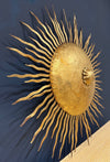 A pair of large 1950s Spanish sunburst wrought iron wall sconces