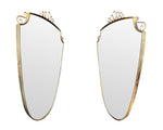 An orignal pair of 1950s Gio Ponti style Italian portrait brass framed mirror with brass top scroll detailing