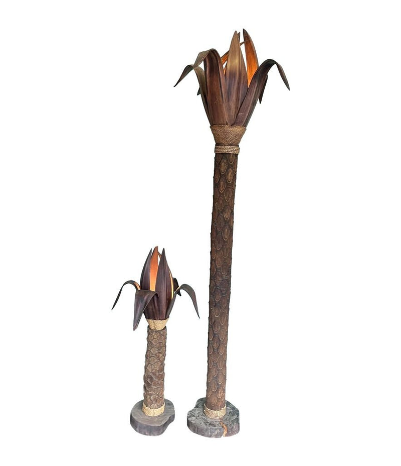 An unusual palm tree floor lamp with real palm trunk, wooden base and wooden shaped leaves