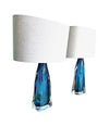 A pair of 1960s Orrefors turquoise glass and brass lamps with new bespoke linen shades