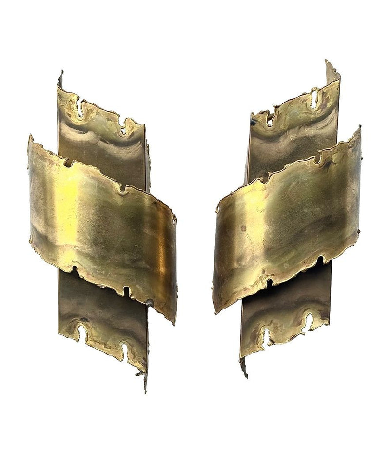 A pair of Danish 1960s torch cut brass wall sconces by Holm Sorensen.