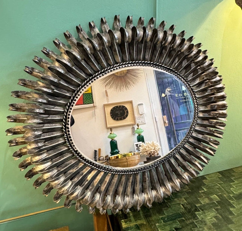 A Spanish 1960s silvered metal landscape or portrait oval eyelash mirror