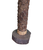 An unusual palm tree floor lamp with real palm trunk wooden base and wooden shaped leaves