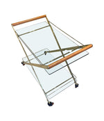 A 1980s Gallotti and Radice “Mister” bar trolley with brass frame and cherry wood handles.