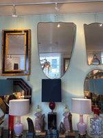 A large orignal Italian 1950s shield mirror with brass frame