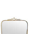 Mid century brass framed mirror with slim profile and scroll top detail