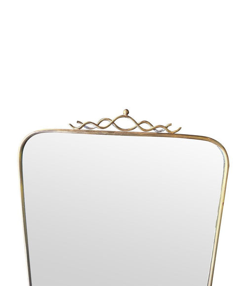 Mid century brass framed mirror with slim profile and scroll top detail