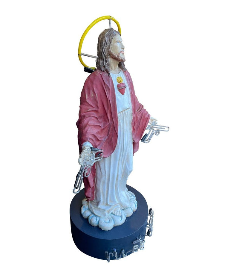 A fantastic original Chris Bracey neon art sculpture of Jesus with neon guns, halo and title on the base “I'll Be Back"