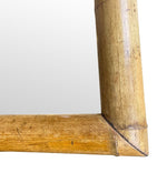 A large square mirror with a thick bamboo frame