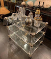 1970S LUCITE AND BRASS BAR TROLLEY WITH 3 GLASS SHELVES AND ORIGINAL CASTORS