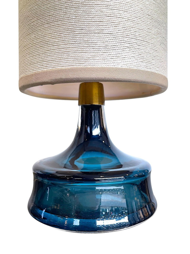 A pair of Swedish Orrefors blue glass lamps by Carl Fagerlund with brass collar