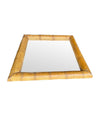 A large square mirror with a thick bamboo frame