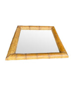 A large square mirror with a thick bamboo frame