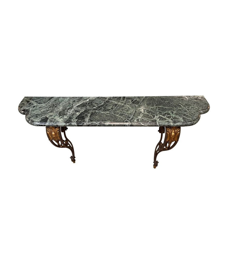 An Art Deco wrought iron gilded console table with green marble top in the style of Gilbert Poillerat