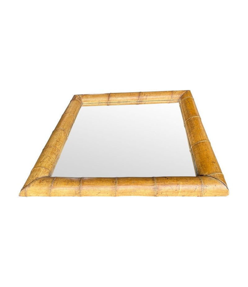 A large square mirror with a thick bamboo frame