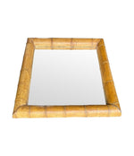 A large square mirror with a thick bamboo frame