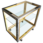 A CHROME AND BRASS BAR CART BY ZEVI