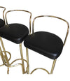 A SET OF FOUR BRASS BAR STOOLS